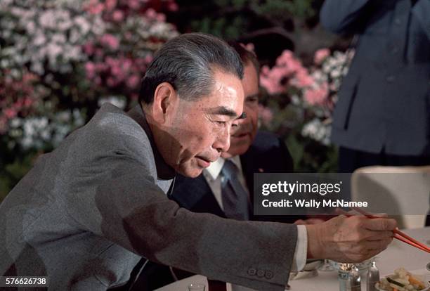 Chinese Premier Chou En-Lai reaches for food with chopsticks at an official banquet held in the Great Hall of the People, during Richard Nixon's...