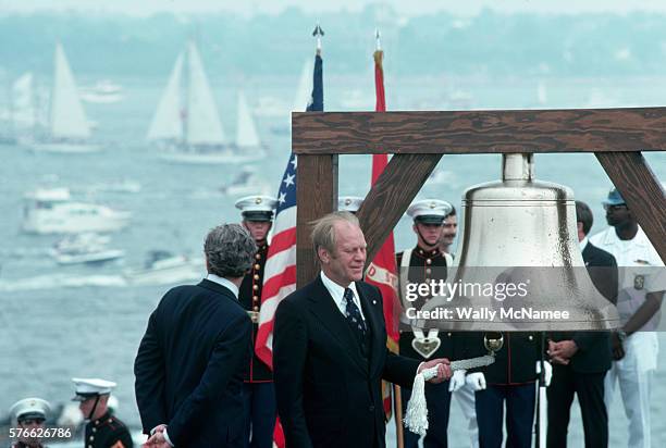 President Ford rings a commemorative bell onboard a US warship in New York Harbor. Ford is participating in the American Bicentennial events.