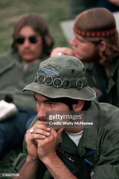 Young Vietnam veteran sits in thoughtful repose at an antiwar rally in Washington, D.C., in the spring of 1971. On his bush hat he wears the CIB and...