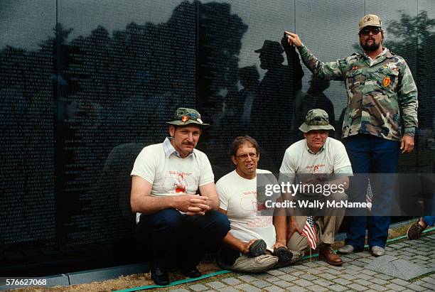 Double amputee Bob Wieland and other Vietnam veterans gather at the Vietnam Veterans Memorial, where Wieland was speaking about the economic plight...