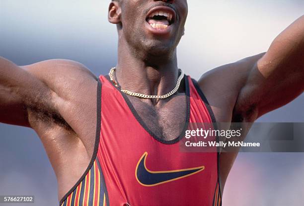 Sprinter Michael Johnson raises his arms in triumph after winning the 200 meter final and breaking the world record in the process.