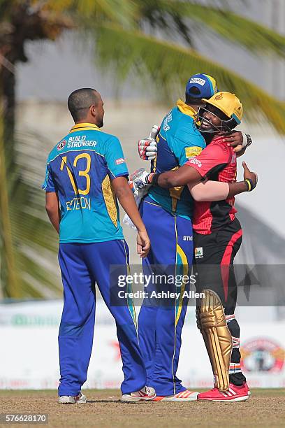 Bridgetown , Barbados - 16 July 2016; Tridents captain Kieron Pollard congratulates Knight Riders captain Dwayne Bravo as Robin Peterson looks on...