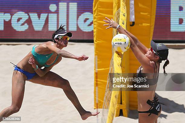 Lane Carico spikes the ball past Angela Bensend during their quarter final match at AVP Beach Volleyball Manhattan Beach on July 16, 2016 in...