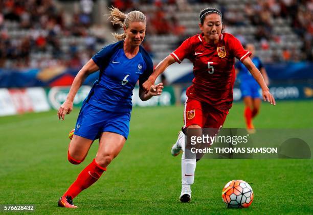 France's midfielder Amandine Henry vies for the ball with China's Defender Wu Haiyan during the women's friendly football match between France and...
