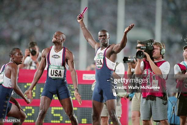 Members of the US men's 4 x 100 meter relay team, who won the silver medal in the event, stand in proud poses.