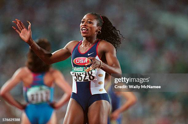 Sprinter Gail Devers celebrates after winning the women's 100 meter semi final race at the 1996 Olympics.