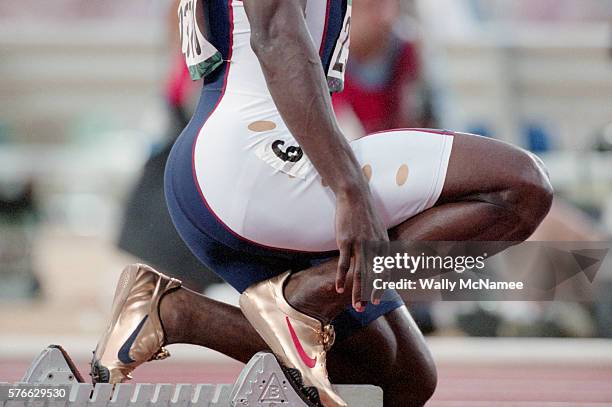 Sprinter Michael Johnson wears his gold shoes as he prepares for the start of his 400 meter heat at Atlanta's Olympic Stadium during the 1996 Olympic...