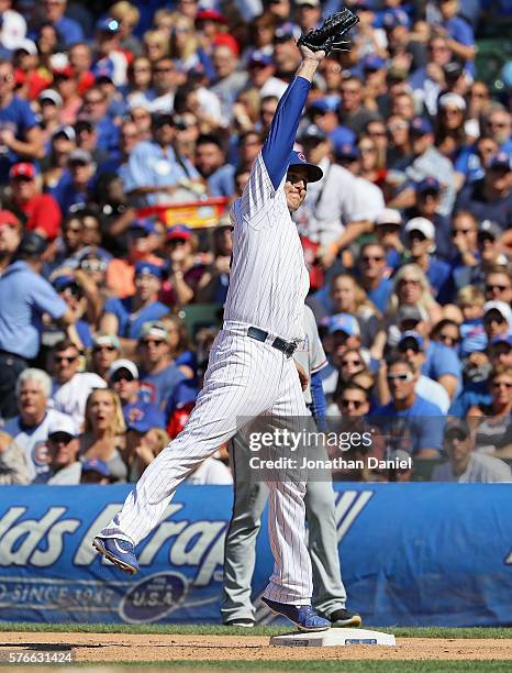 Anthony Rizzo of the Chicago Cubs leaps to make a catch to force Bobby Wilson of the Texas Rangers at first base in the 8th inning at Wrigley Field...