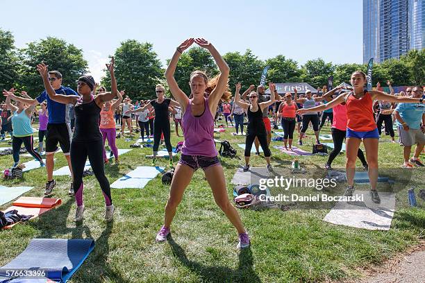 Fitbit Local Ambassadors Jeremy Walton and Jenny Finkel lead participants in a bootcamp and yoga workout during the launch of Fitbit Local Free...