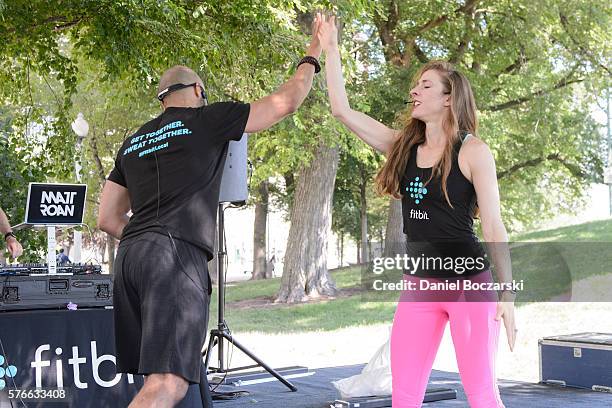 Fitbit Local Ambassadors Jeremy Walton and Jenny Finkel lead participants in a bootcamp and yoga workout during the launch of Fitbit Local Free...