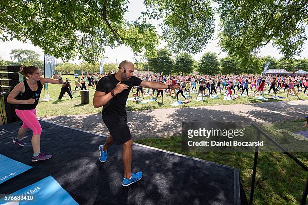 Fitbit Local Ambassador Jeremy Walton leads participants in a bootcamp session during the launch of Fitbit Local Free Community Workouts In Chicago...