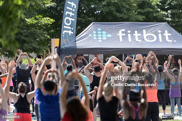 Fitbit Local Ambassadors Jeremy Walton and Jenny Finkel lead participants in a bootcamp and yoga workout during the launch of Fitbit Local Free...