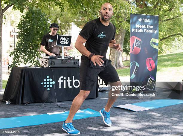 Fitbit Local Ambassador Jeremy Walton leads participants in a bootcamp session during the launch of Fitbit Local Free Community Workouts In Chicago...