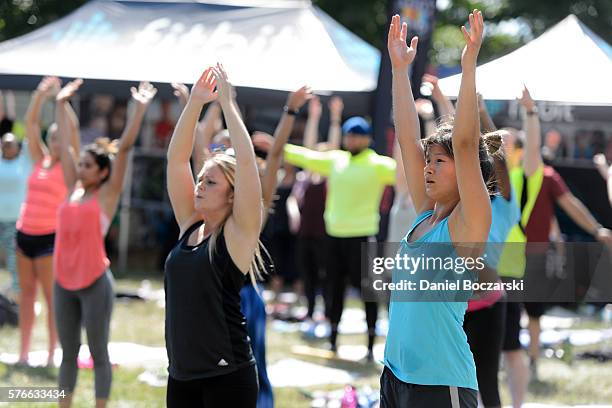 Fitbit Local Ambassadors Jeremy Walton and Jenny Finkel lead participants in a bootcamp and yoga workout during the launch of Fitbit Local Free...