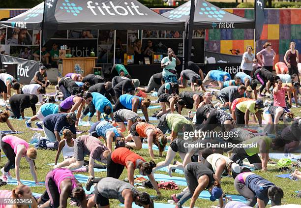 Fitbit Local Ambassadors Jeremy Walton and Jenny Finkel lead participants in a bootcamp and yoga workout during the launch of Fitbit Local Free...