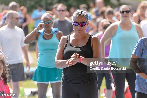 Fitbit Local Ambassadors Jeremy Walton and Jenny Finkel lead participants in a bootcamp and yoga workout during the launch of Fitbit Local Free...