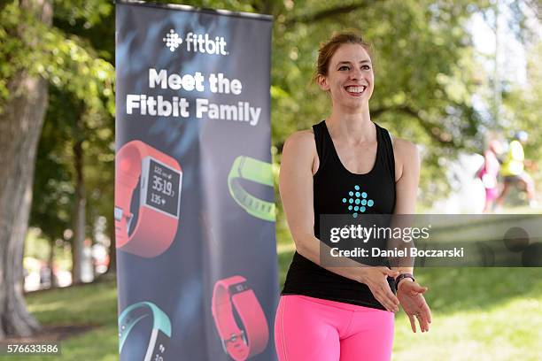 Fitbit Local Ambassador Jenny Finkel leads participants in a yoga workout during the launch of Fitbit Local Free Community Workouts In Chicago at...