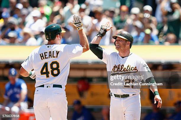 Ryon Healy of the Oakland Athletics celebrates with Stephen Vogt of the Oakland Athletics after hitting a home run in the second inning against the...