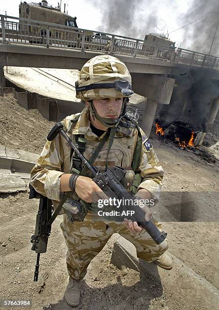 British soldier secures the site where a military vehicle is buring in the southern city of Basra, 20 May 2006. Two British soldiers were wounded...