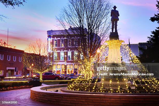 bentonville square confederate solder with christmas lights at twilight - 576641934,576641958,576641932,576641946,576641956,576641950,576641960,576641970,576641966,576641998,584688394,584688600,584688988 stock pictures, royalty-free photos & images