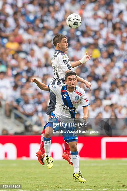 Hiram Mier of Monterrey heads the ball over Christian Bermudez of Puebla during the 1st round match between Monterrey and Puebla as part of the...