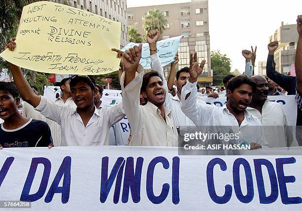 Activists of a Pakistani right wing Islamic party, Jamaat-i-Islami, join Christians as they shout slogans against Dan Brown's "The Da Vinci Code"...