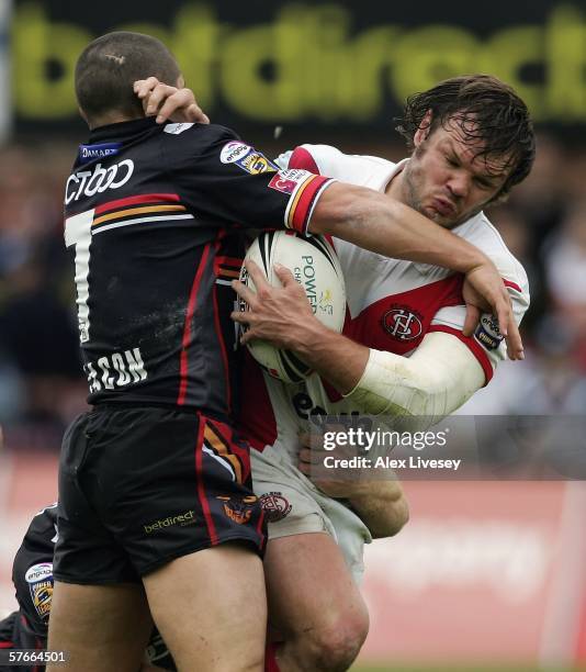 Keiron Cunningham of St. Helens is tackled Paul Deacon of Bradford Bulls during the Powergen Cup Fifth Round match between St. Helens and Bradford...