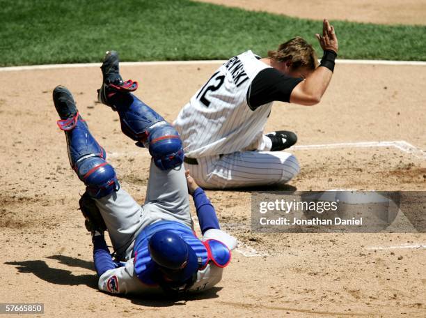 Pierzynski of the Chicago White Sox prepares to slap home base after colliding with Michael Barrett of the Chicago Cubs on a sacrifice fly in the...