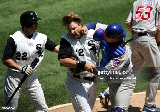 Michael Barrett of the Chicago Cubs punches A.J. Pierzynski of the Chicago White Sox after a second inning collision as Scott Podsednik steps in on...