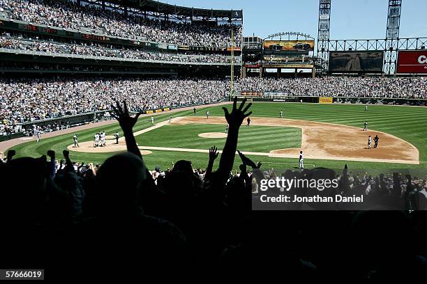 Fans cheer as Tadahito Iguchi of the Chicago White Sox rounds third base after hitting a grand slam home run in the 2nd inning against the Chicago...