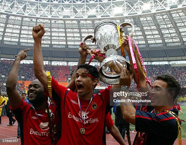 Moscow players Vagner Love, Dudu and Daniel Carvalho of Brazil celebrate as they hold the Russian Cup trophy after winning the final against Spartak...