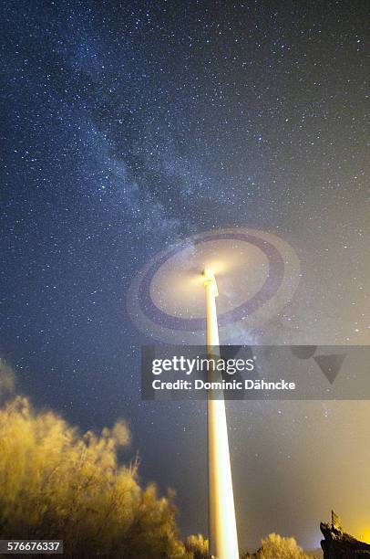 windmill with milky way - wind turbine long exposure stock-fotos und bilder