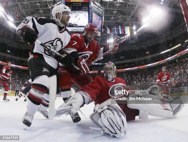 Cam Ward and Niclas Wallin of the Carolina Hurricanes defend against Derek Roy of the Buffalo Sabres in game one of the Eastern Conference Finals...