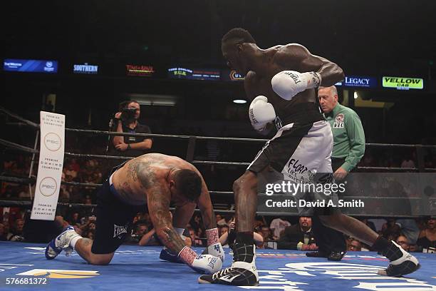 Chris Arreola is taken down by WBC World Heavyweight Champion Deontay Wilder during a title fight at Legacy Arena at the BJCC on July 16, 2016 in...