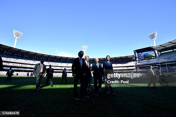 Vice-President Joe Biden walks across the field with AFL CEO Gillon McLachlan , Mike Fitzpatrick and Chair of the MCC Steven Smith before the round...