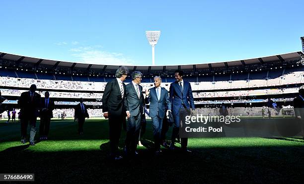 Vice-President Joe Biden walks across the field with AFL CEO Gillon McLachlan , Mike Fitzpatrick and Chair of the MCC Steven Smith before the round...