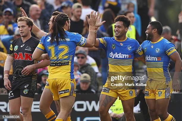 Bureta Faraimo of the Eels celebrates with his team mates after scoring a try during the round 19 NRL match between the Penrith Panthers and the...