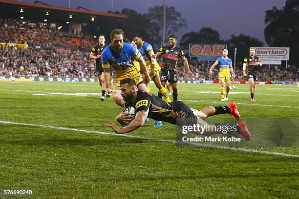 Josh Mansour of the Panthers scores a try during the round 19 NRL match between the Penrith Panthers and the Parramatta Eels at Pepper Stadium on...