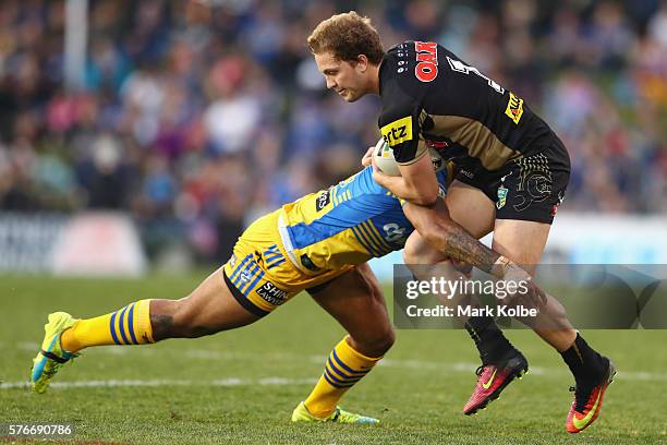 Manu Ma'u of the Eels tackles Matt Moylan of the Panthers during the round 19 NRL match between the Penrith Panthers and the Parramatta Eels at...