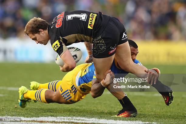 Manu Ma'u of the Eels tackles Matt Moylan of the Panthers during the round 19 NRL match between the Penrith Panthers and the Parramatta Eels at...