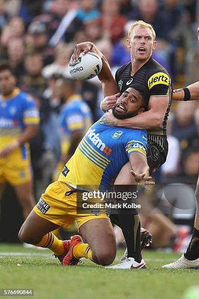 Michael Jennings of the Eels is tackled by Peter Wallace of the Panthers during the round 19 NRL match between the Penrith Panthers and the...