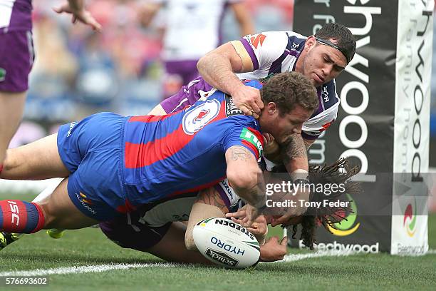 Korbin Sims of the Knights drops the ball as he attempts to score a try during the round 19 NRL match between the Newcastle Knights and the Melbourne...