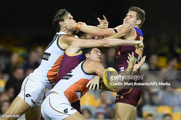 Jonathon Patton and Rory Lobb of the Giants competes for the ball against Harris Andrews and Matthew Hammelmann of the Lions during the round 17 AFL...