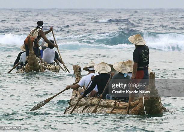 Two boats made of bulrush leave Yonaguni Island for Iriomote Island, both in Okinawa Prefecture, on July 17 on a journey to replicate part of a...