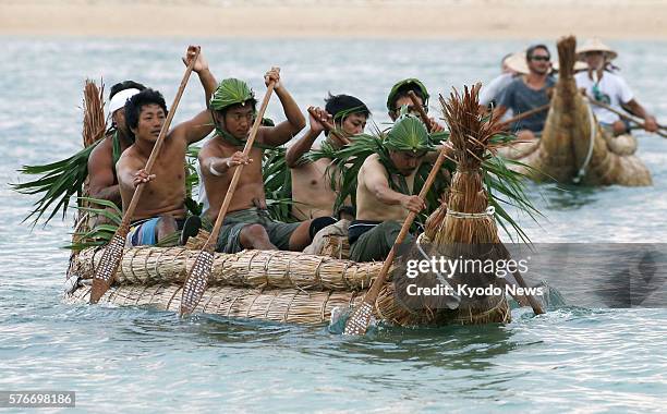 Two boats made of bulrush prepare to leave Yonaguni Island for Iriomote Island, both in Okinawa Prefecture, on July 17 on a journey to replicate part...