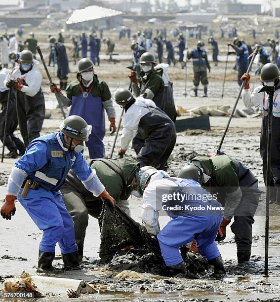 Japan - Members of the Self-Defense Forces search for missing people during an intensive search operation in Higashimatsushima, Miyagi Prefecture, on...