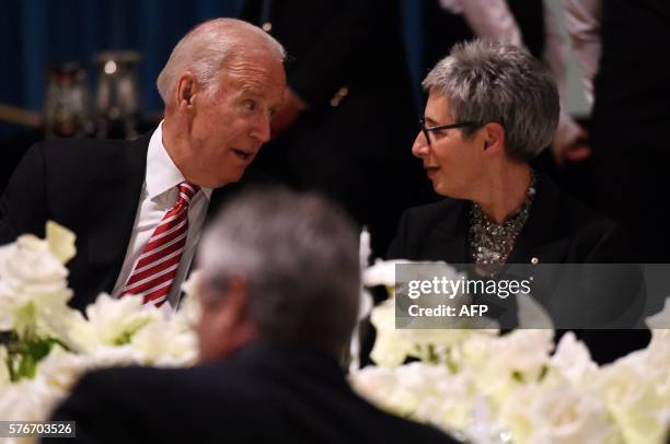 Vice President Joe Biden speaks to the Governor of Victoria state Linda Dessau during a dinner at Government House in Melbourne on July 17, 2016....