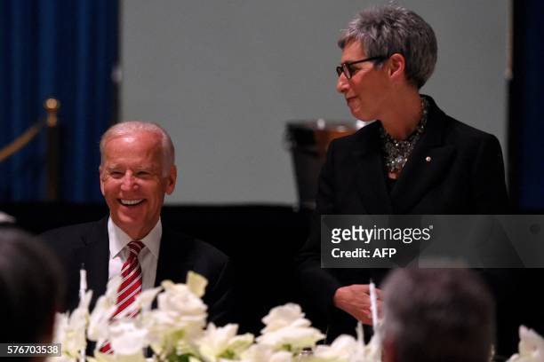 Vice President Joe Biden listens to the Governor of Victoria state Linda Dessau give a speech during a dinner at Government House in Melbourne on...