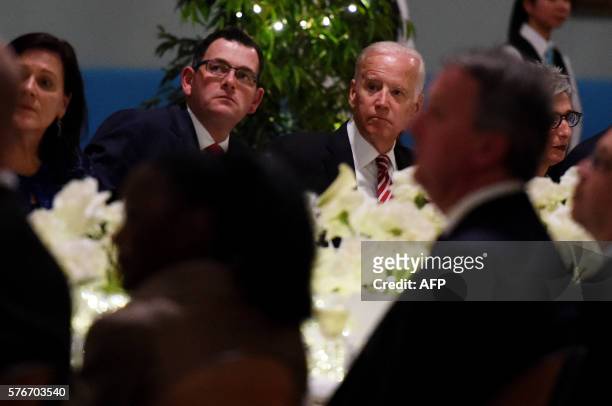 Vice President Joe Biden sits with Victorian Premier Daniel Andrews as they listen to a musical performance during a dinner at Government House in...