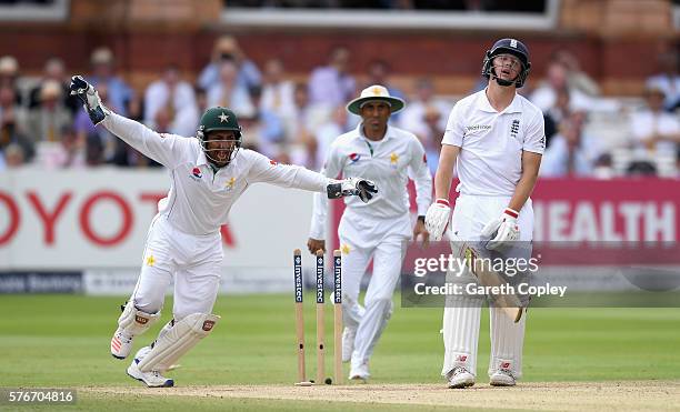 Gary Ballance of England reacts after being bowled by Yasir Shah of Pakistan as Sarfraz Ahmed celebrates during day four of the 1st Investec Test...